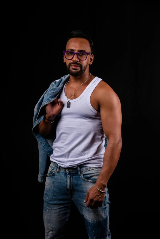a man with glasses posing for a po
