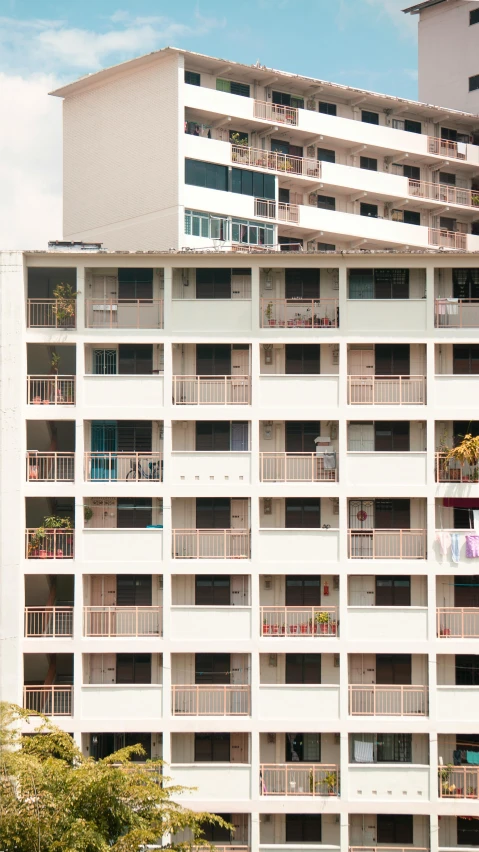 a very large building with many balconies on the windows