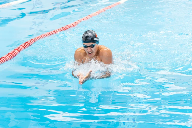 a swimmer swimming in the water with goggles on