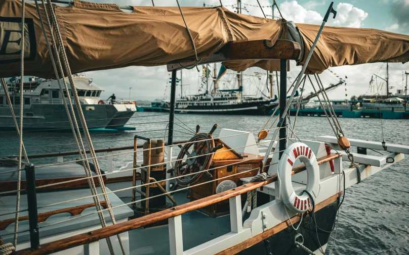 several sailboats in a harbor with some brown tarp