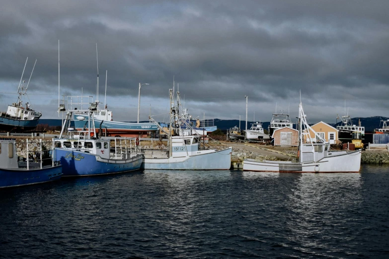 several fishing boats on the water in a marina