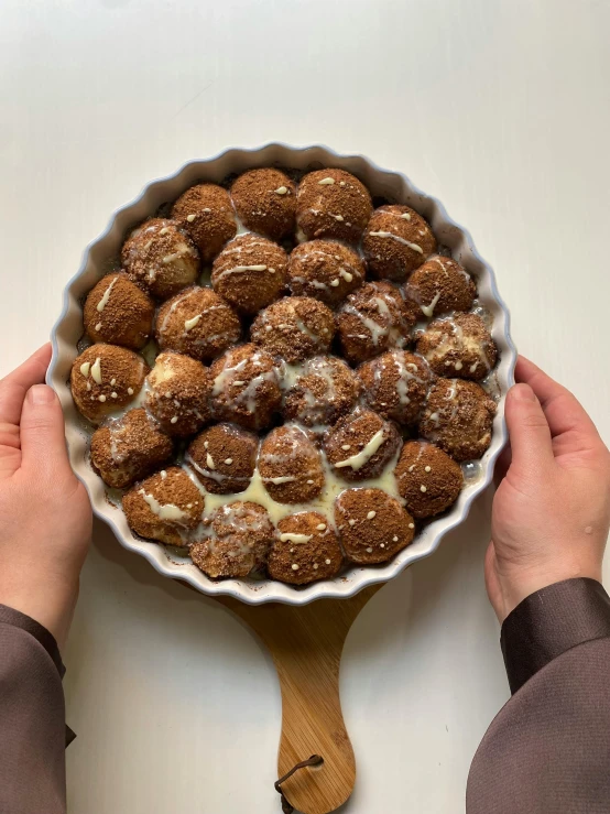 someone is holding up a bowl of small desserts