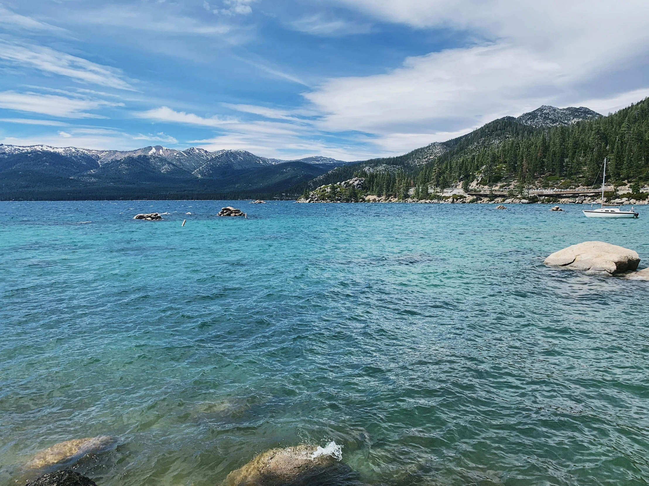 a large body of water with a mountain in the background