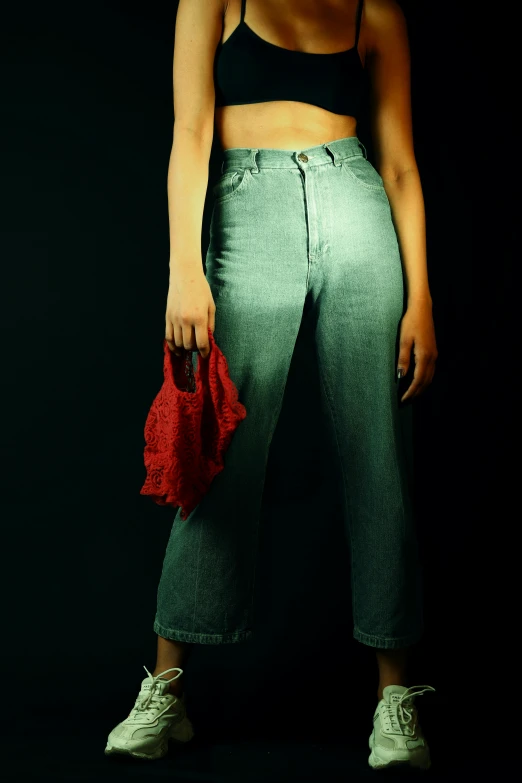 a young woman is standing in front of a dark background