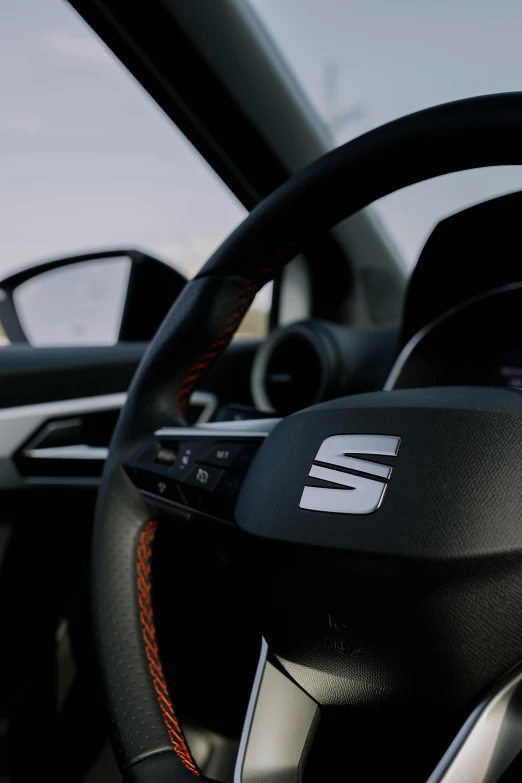 the interior of a car with steering wheel and dashboard