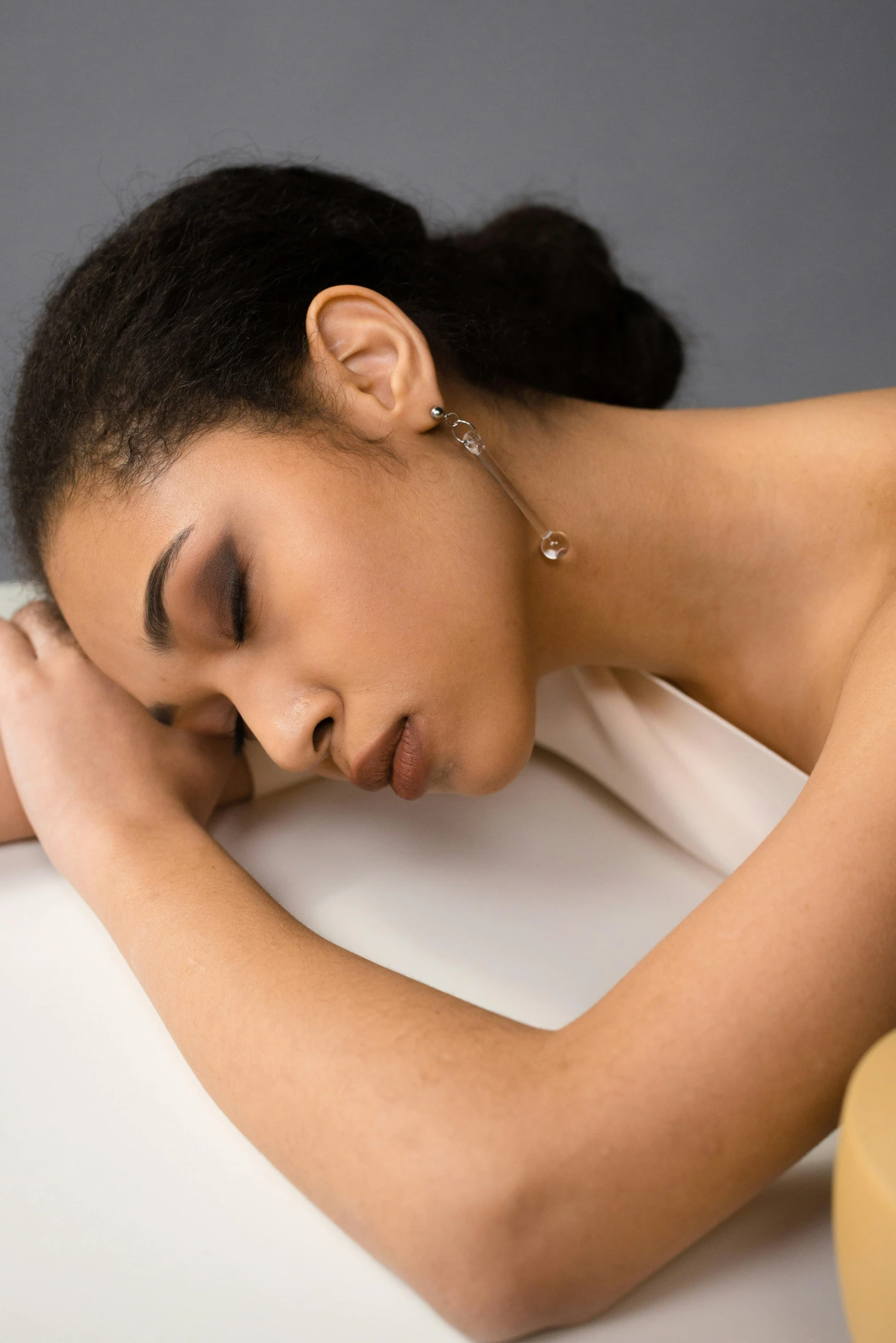 an  woman rests her head on her pillow