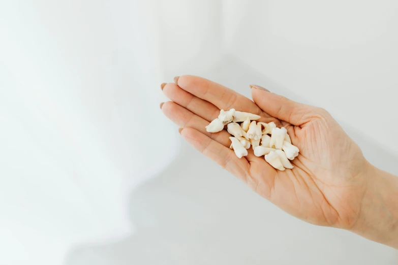 a person holding white food that includes chopped vegetables