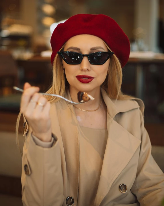 a woman is holding a fork up to eat food