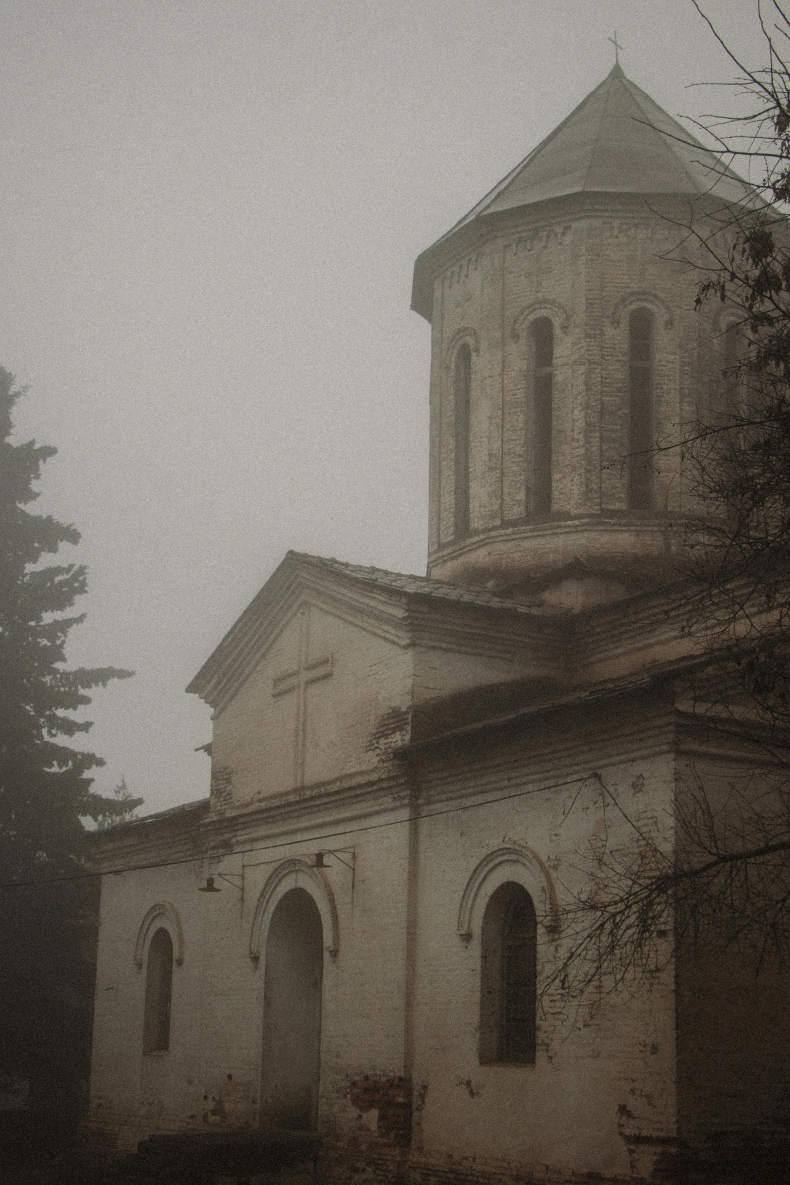 a tall church is shown against the sky