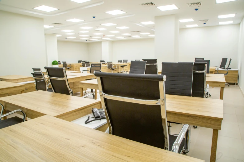 a room full of wooden desk and chairs