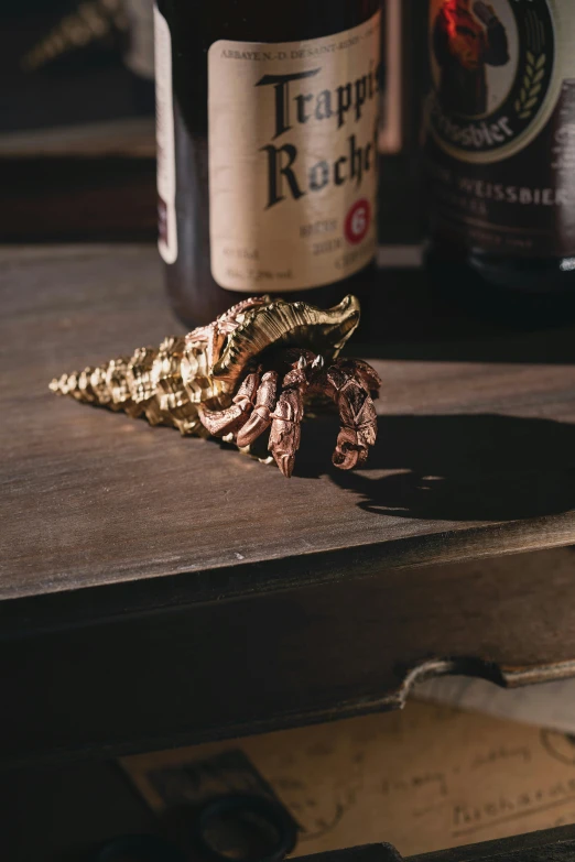 a bottle of beer with a leaf decoration on it