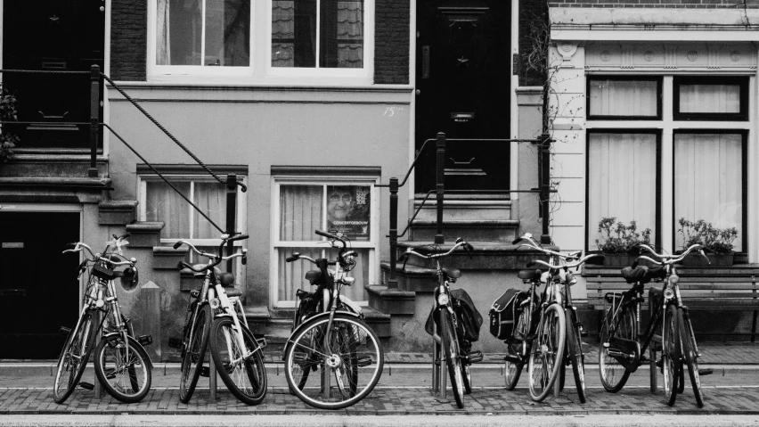 some bikes are lined up in front of some windows