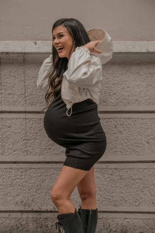 a woman standing on her feet in high heels with a smile on her face