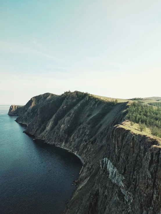 a rock face that is overlooking the ocean