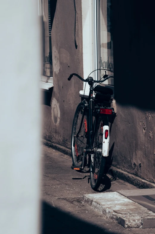 a bike is parked next to a building