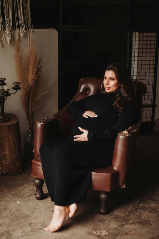 a woman is in a chair posing for the camera