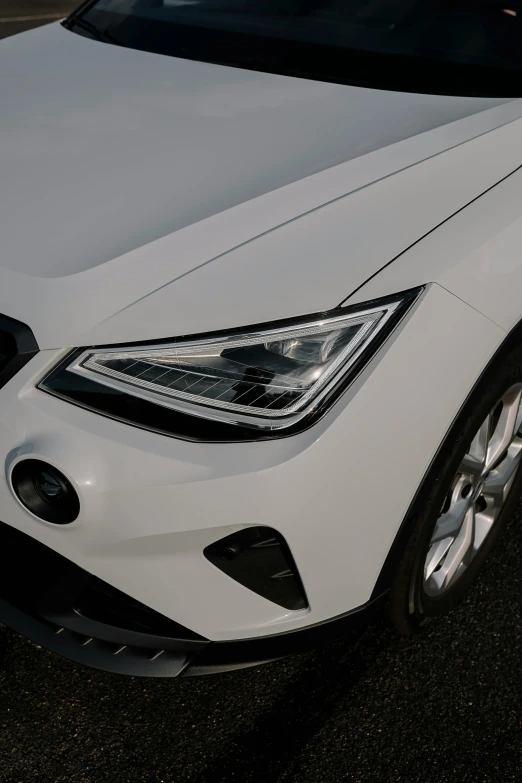 a white mercedes vehicle parked on the side of a road