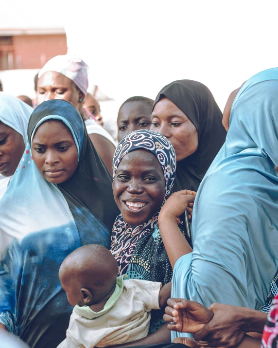 a group of women from different regions in blue headscarves