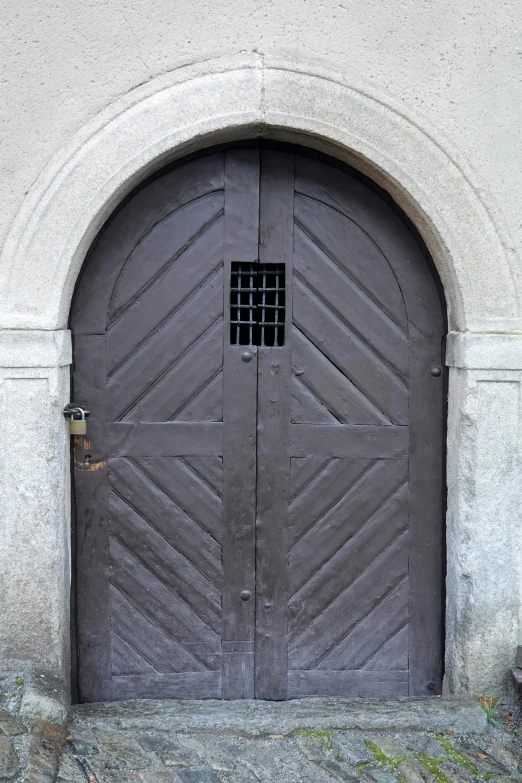 a large brown door with a window behind it