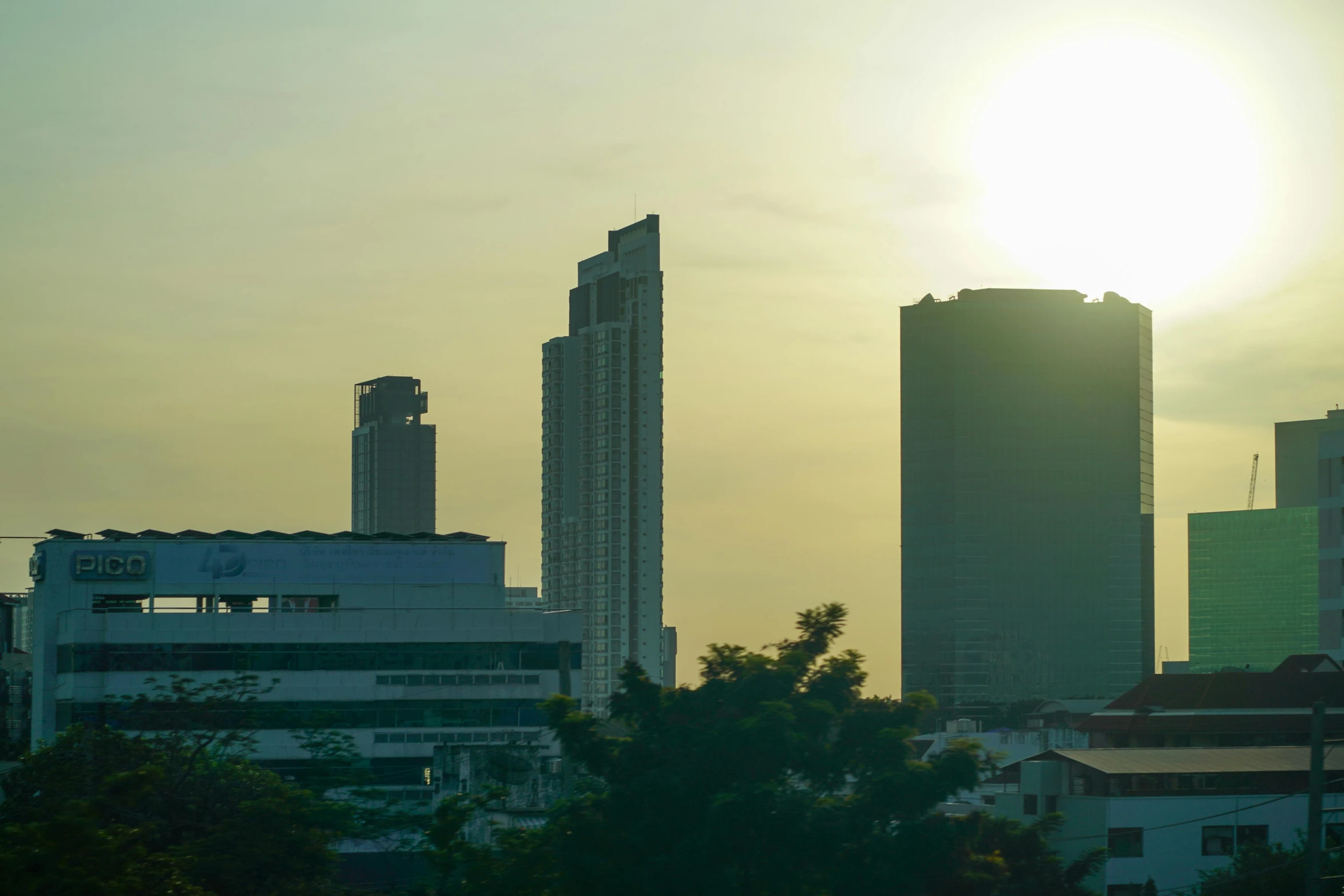 a city is shown with several buildings and trees