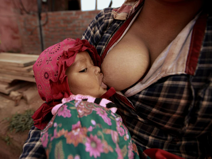 a girl in a bonnet kissing another girl