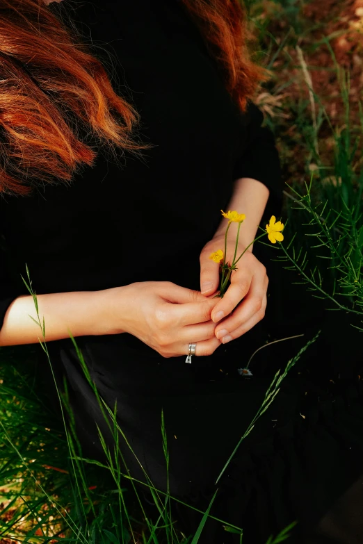 a woman is holding flowers in her hand