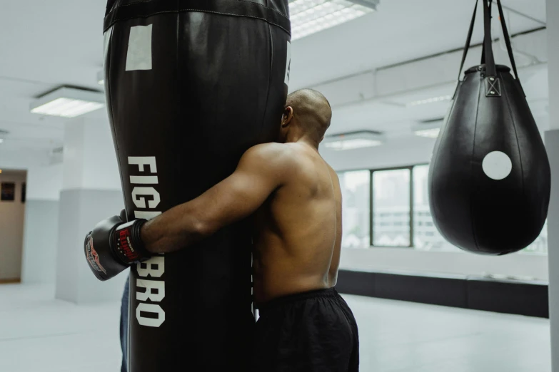 a man is using his hand to put a punching bag into a punching bag