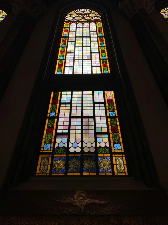 a colorfully painted glass window above an altar