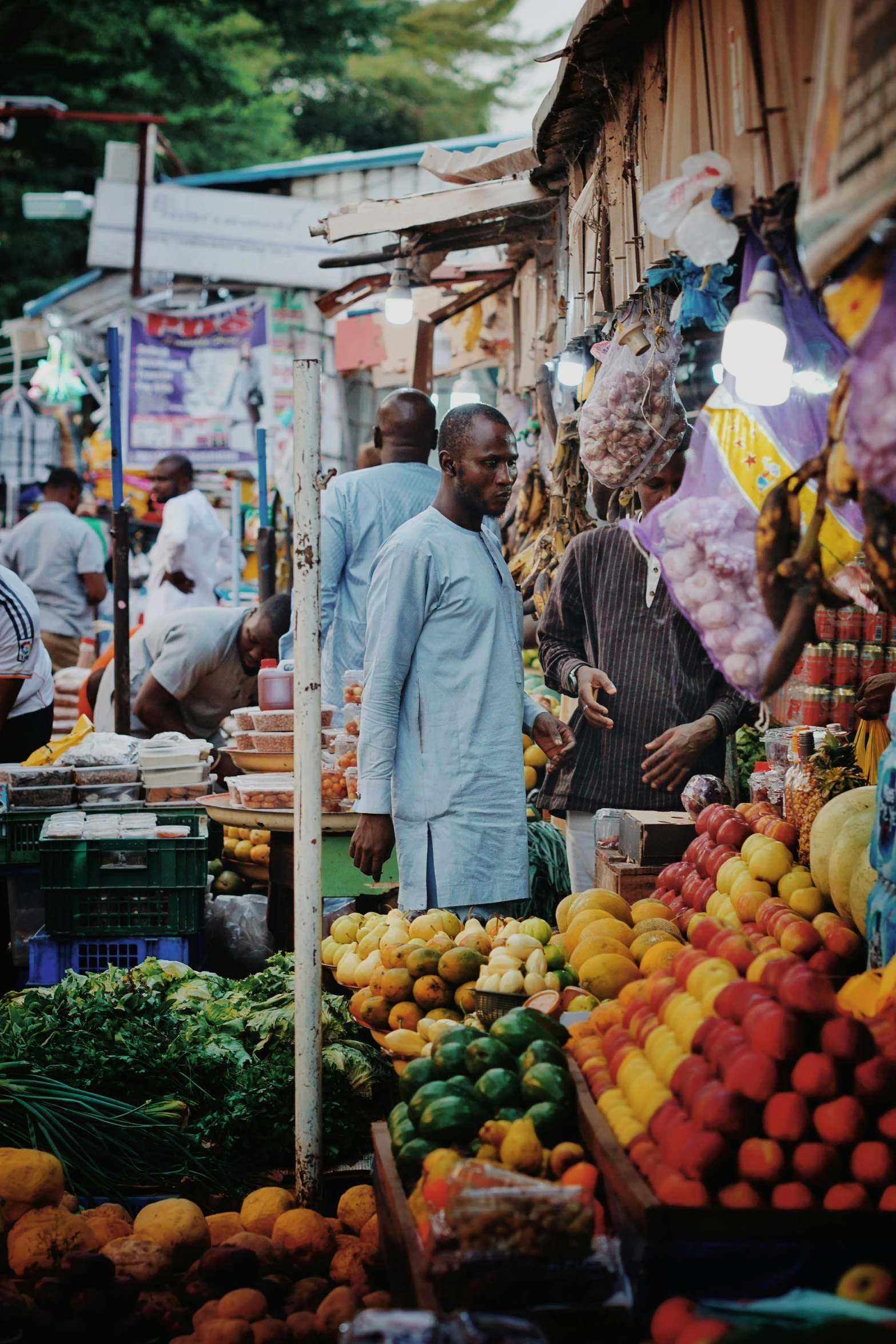 some people in front of some very pretty fruits