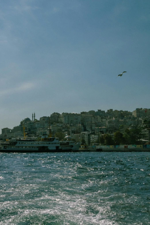 an airplane is flying over a large boat on the water