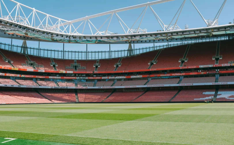 an empty stadium with empty seating on the sides