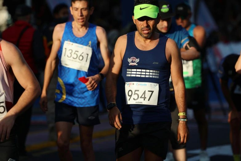 a group of running men are finishing a race