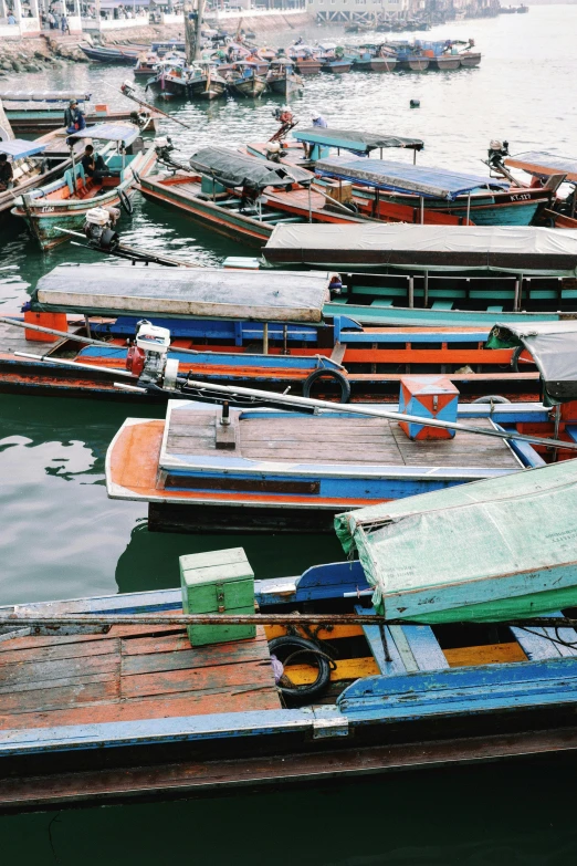 some boats are moored near a city in the water