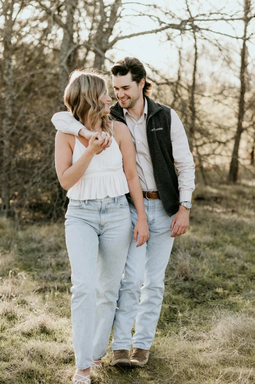 a man and woman posing in the grass