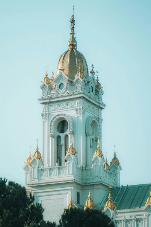 the top of a white building with gold domes