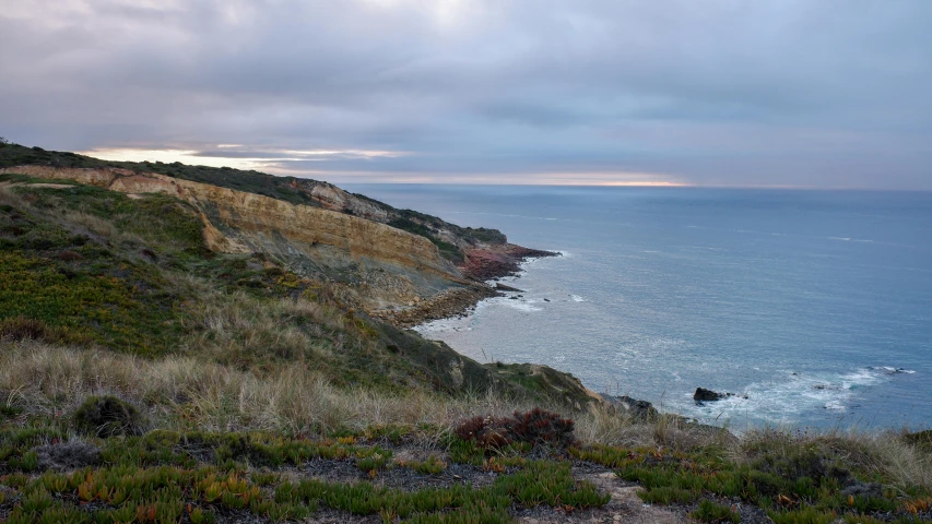 a body of water and land near the top of a cliff