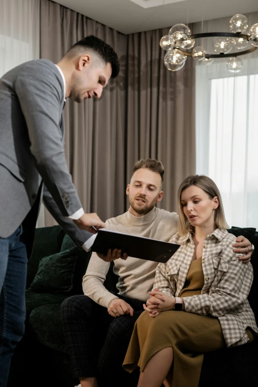 a man looking at soing near two women on a couch