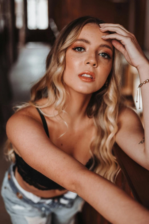 blond woman posing and wearing shorts and a tank top