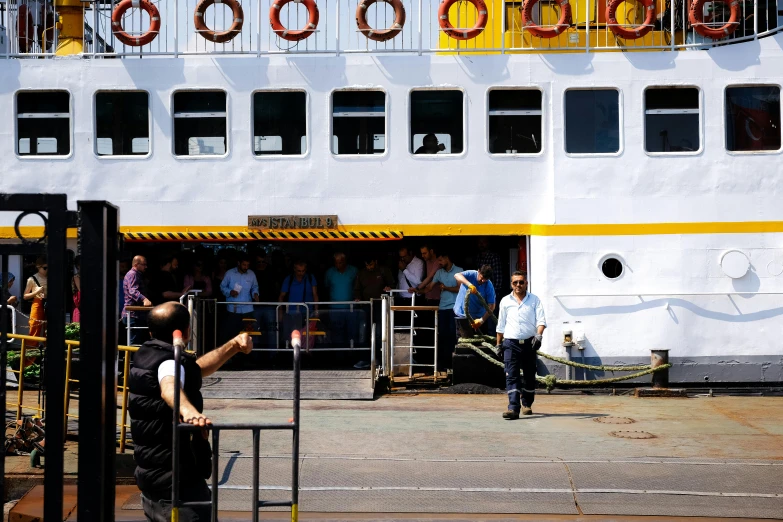 a white passenger boat docked next to a dock