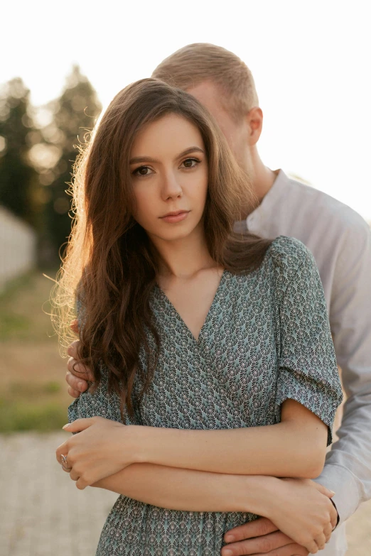 a man standing with his arms wrapped around a girl