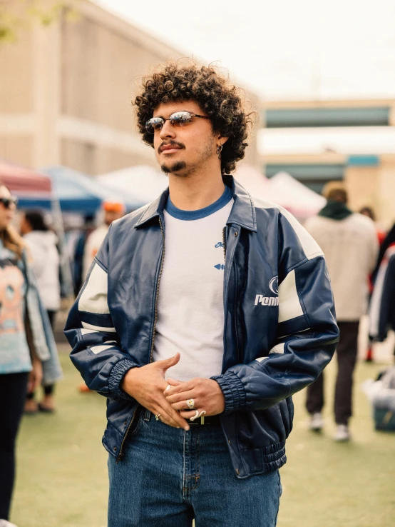 a man with curly hair and glasses on at a gathering