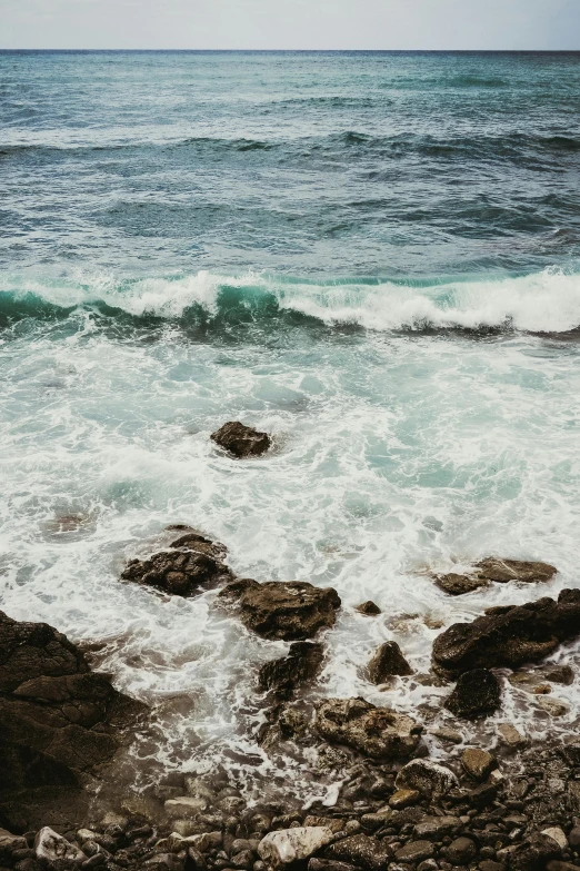 a beach with an ocean wave coming in at the top