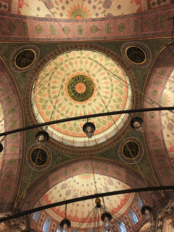 looking up at the intricate ceiling and stained glass dome