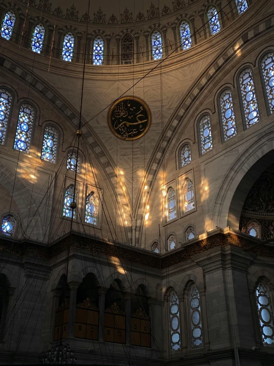 a large room with some light shining through the windows