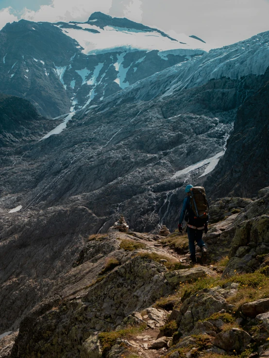 a man with a backpack on a steep slope