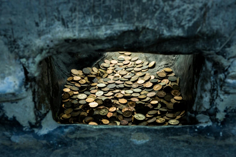 several penny coins are laying in an iron grate