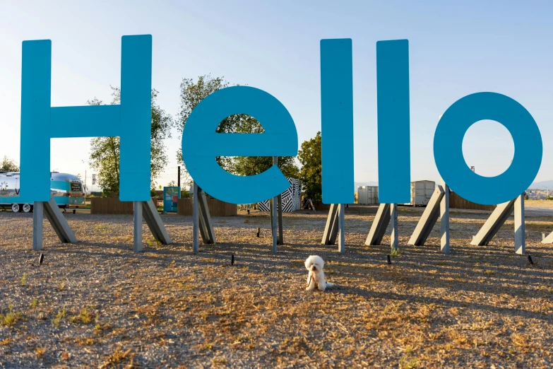 a large blue sign that reads hello with two animals next to it