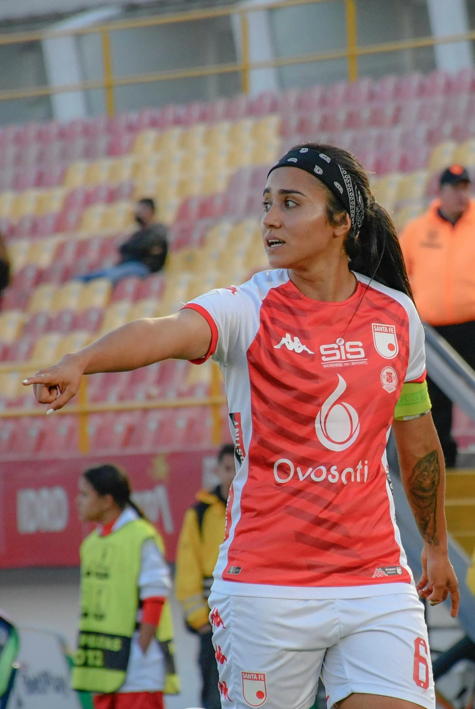 female soccer player preparing to kick ball while a crowd watches