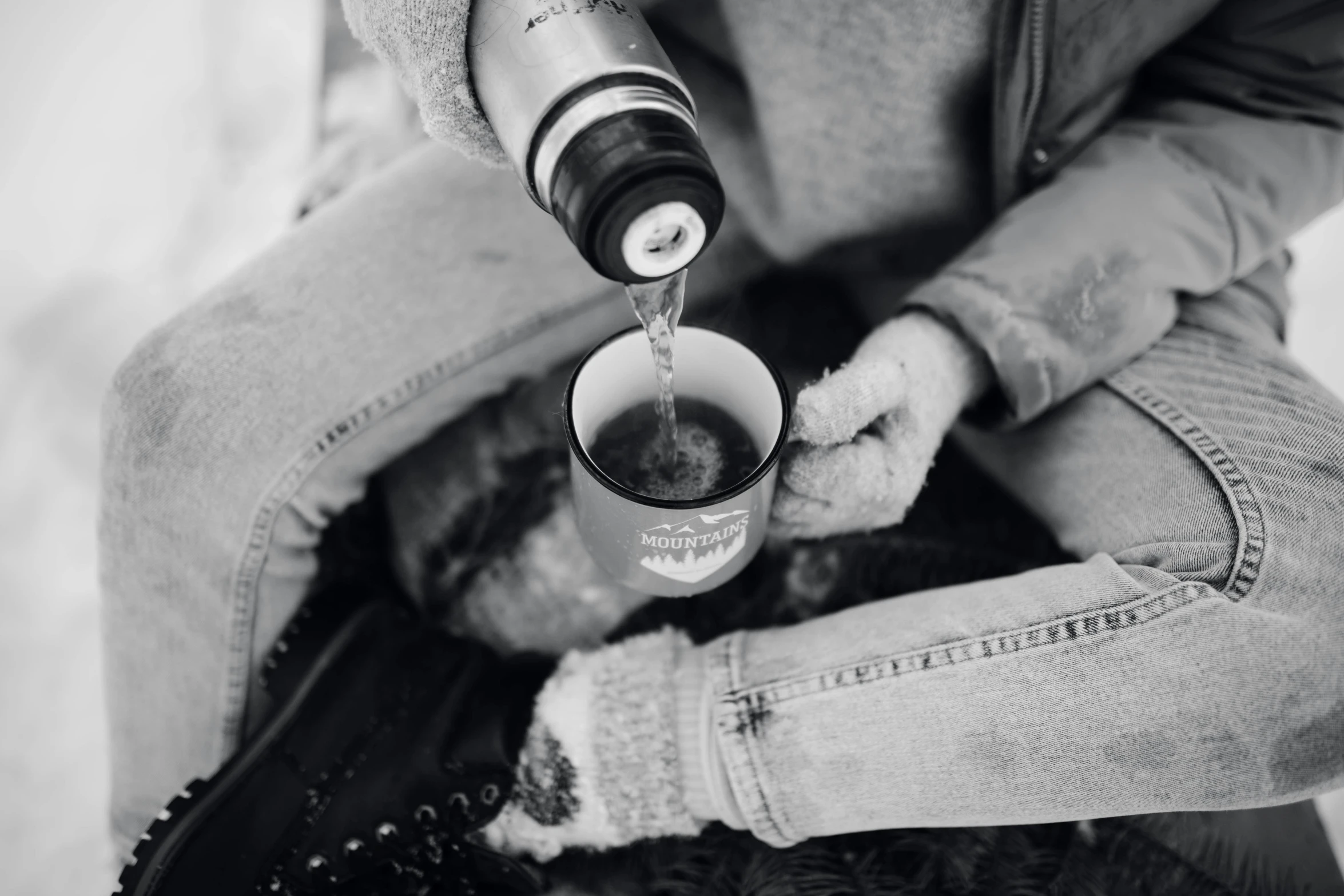 black and white pograph of person pouring liquid