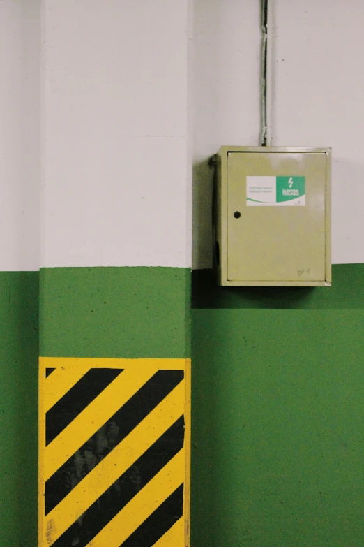 a switch is mounted on a green wall